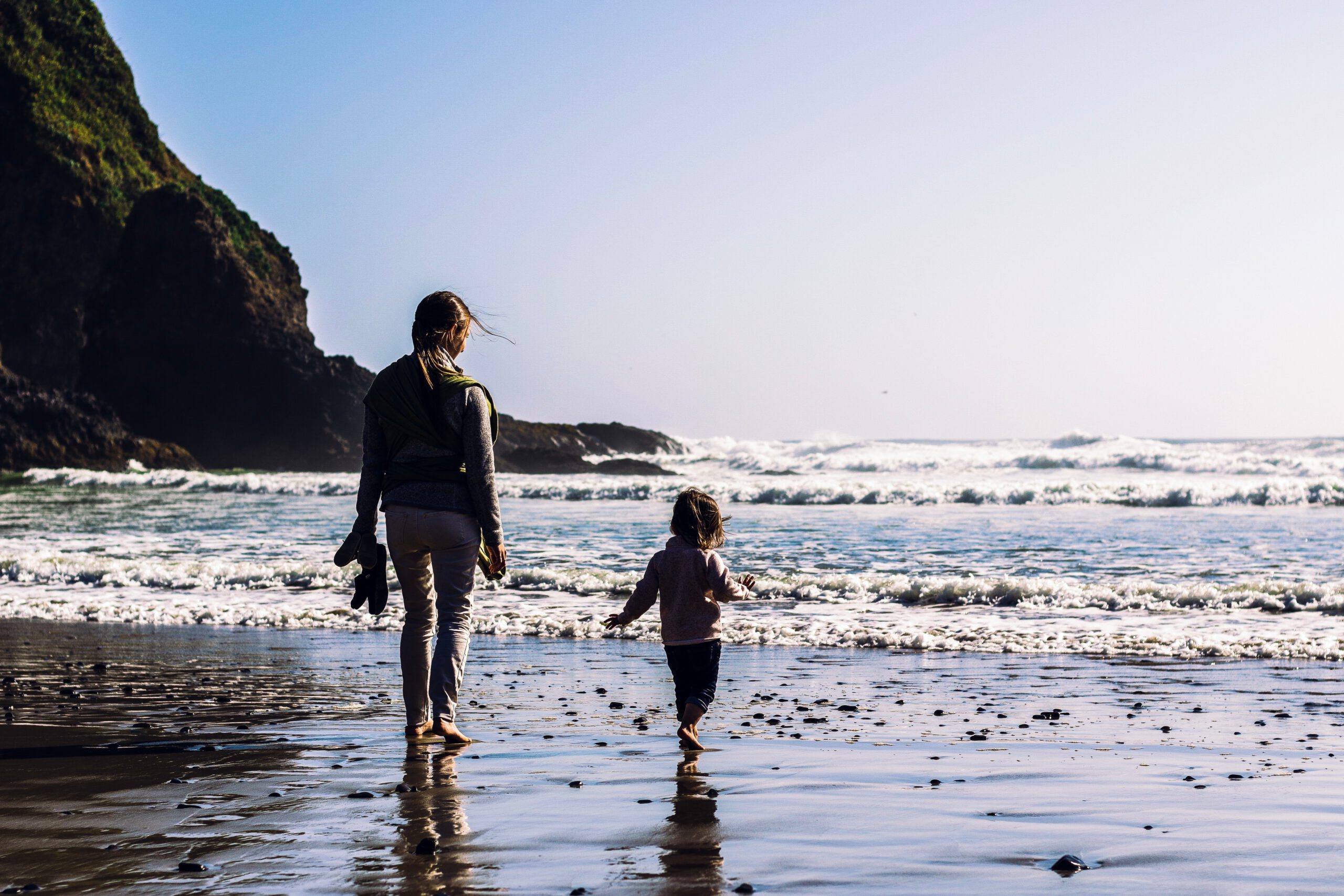 girl-and-toddler-walking-at-the-shore-2405903